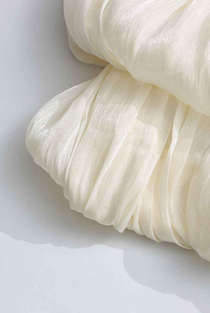 Champagne pleated fabric detail on puff sleeves with gathered texture