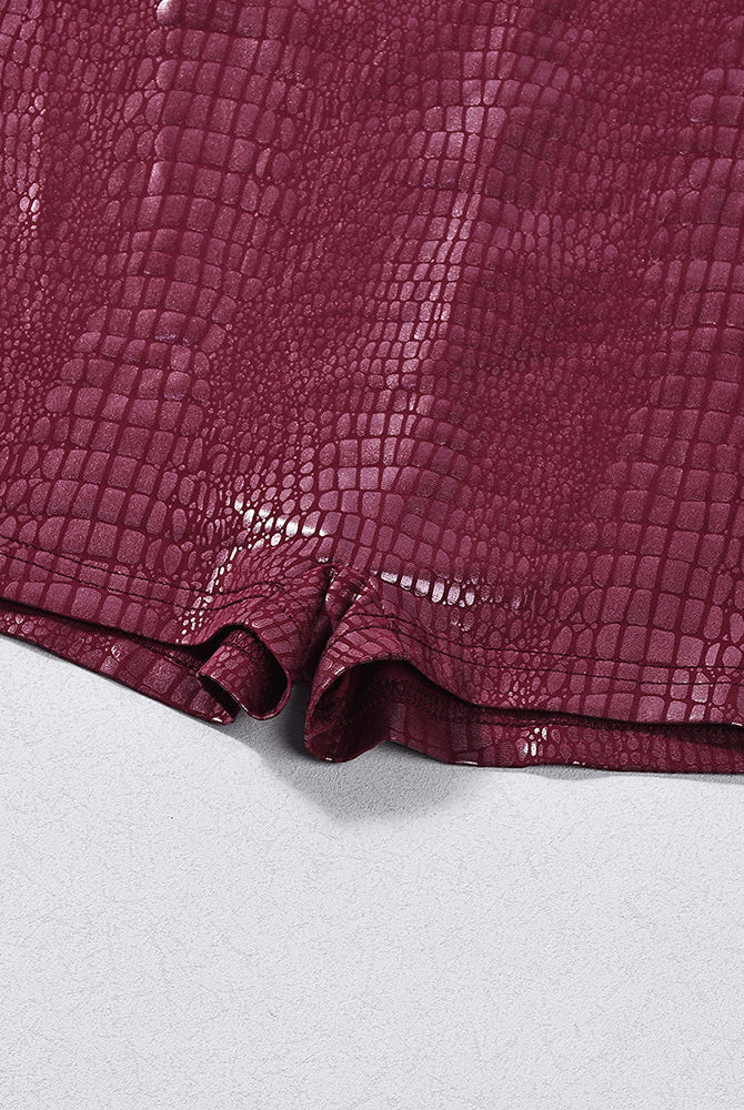 Burgundy croc-embossed faux leather romper bodysuit, close-up of shorts hem
