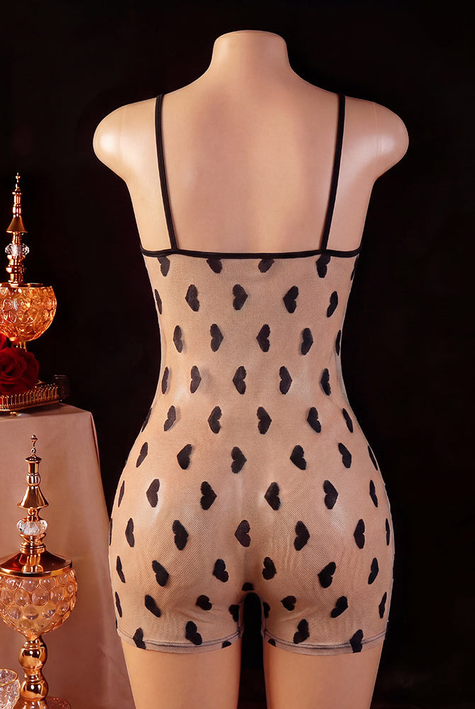 Back view of black romper on mannequin with heart-pattern mesh panel and thin straps