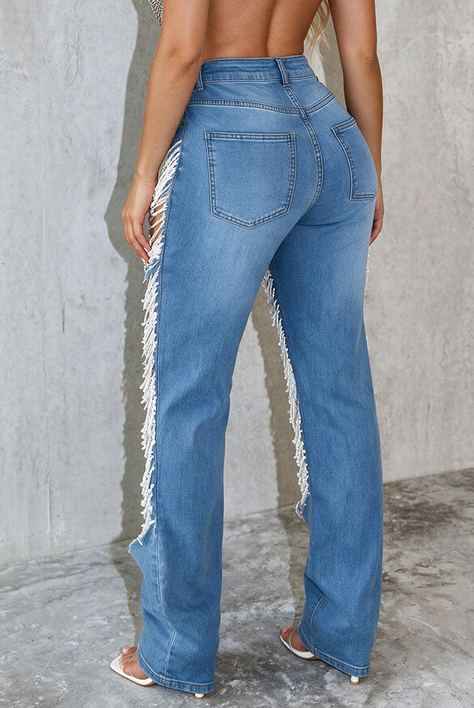 Light blue denim jeans with ripped details and frayed hem