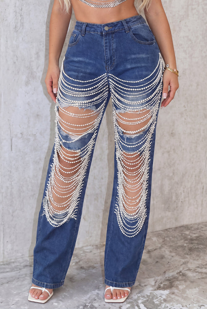 Light blue denim jeans with pearl chain drape across front