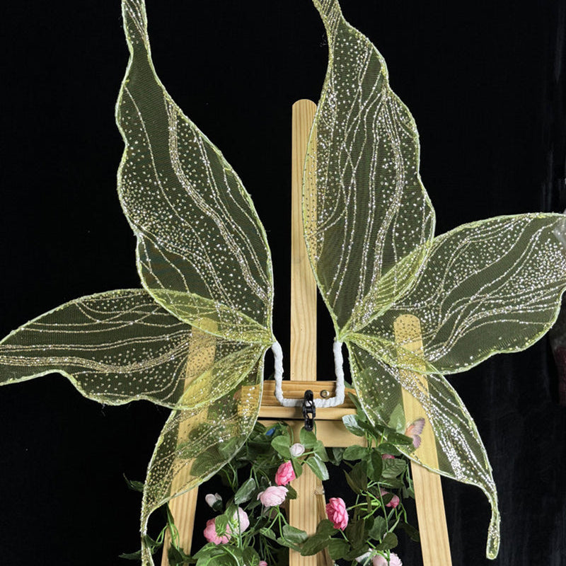 Glitter fairy wings accessory in yellow-green with shimmering, vein-like sparkle lines