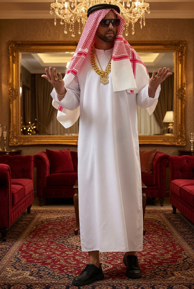 White long robe with red check headscarf and gold chain, black sandals, standing