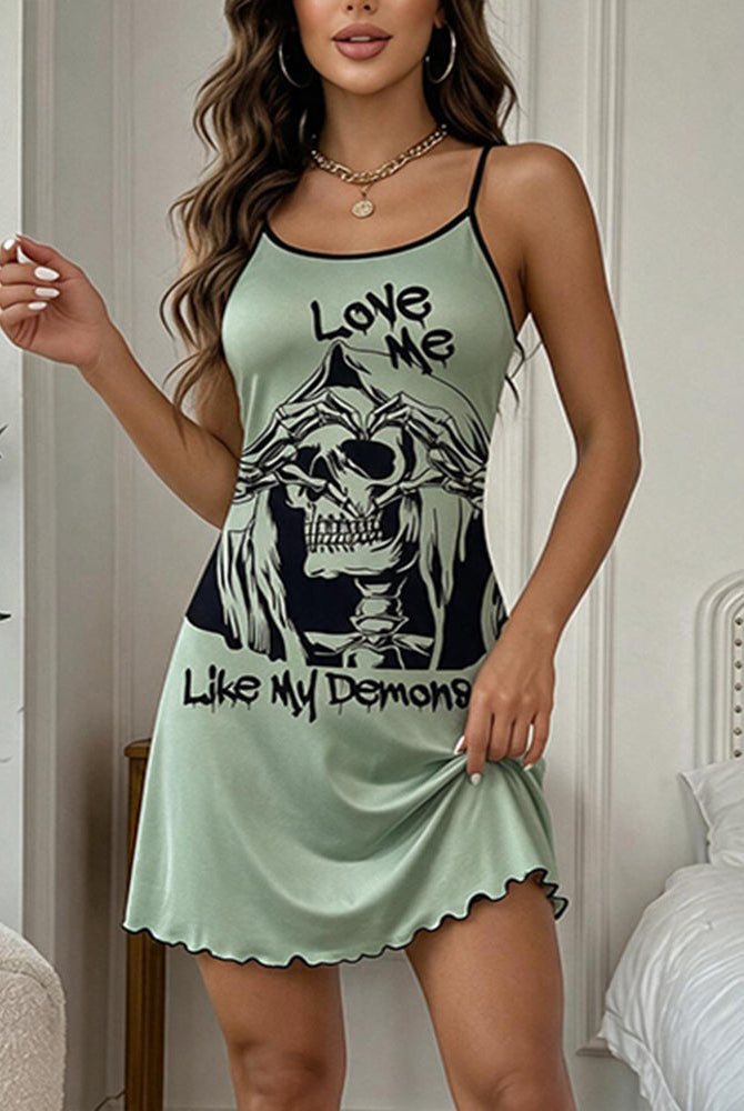 Seafoam green mini slip dress with skull graphic front, spaghetti straps, scalloped hem