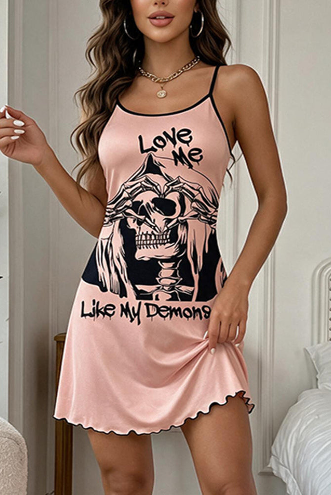 Pink mini slip dress with skull graphic front, spaghetti straps, scalloped hem