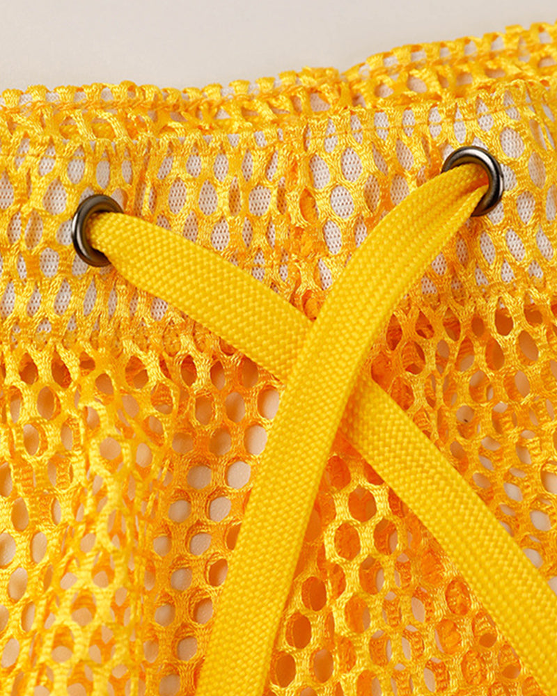 Yellow open mesh shorts close-up with drawstring and metal eyelets.