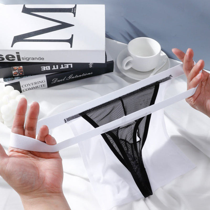 Black sheer g-string thong with elastic waistband, shown with white satin pouch
