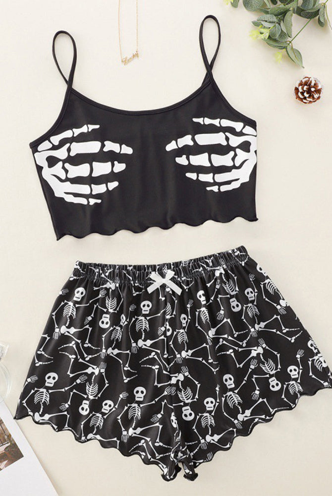 Black skeleton-print cami crop top and matching pajama shorts set, flat lay