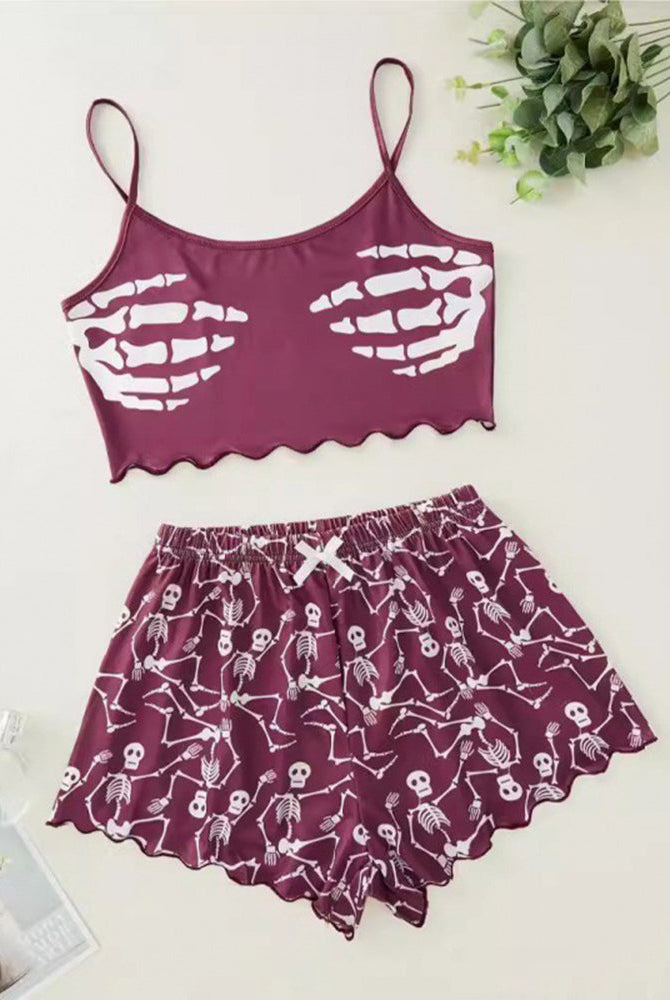 Purple skeleton-print cami crop top and matching pajama shorts set, flat lay
