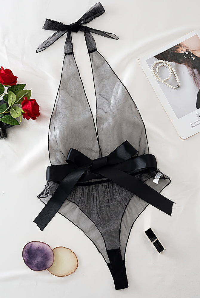 Black sheer mesh halter bodysuit with deep V and satin bow, flat lay