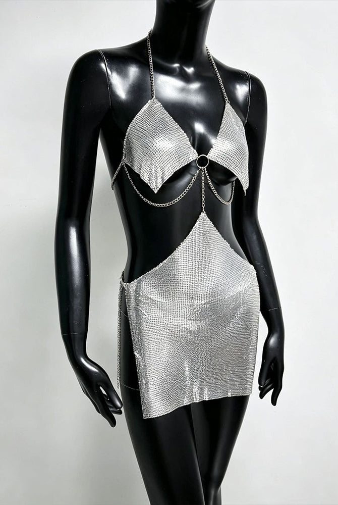 Silver metallic chain bra top and mini skirt set on mannequin with ring centerpiece