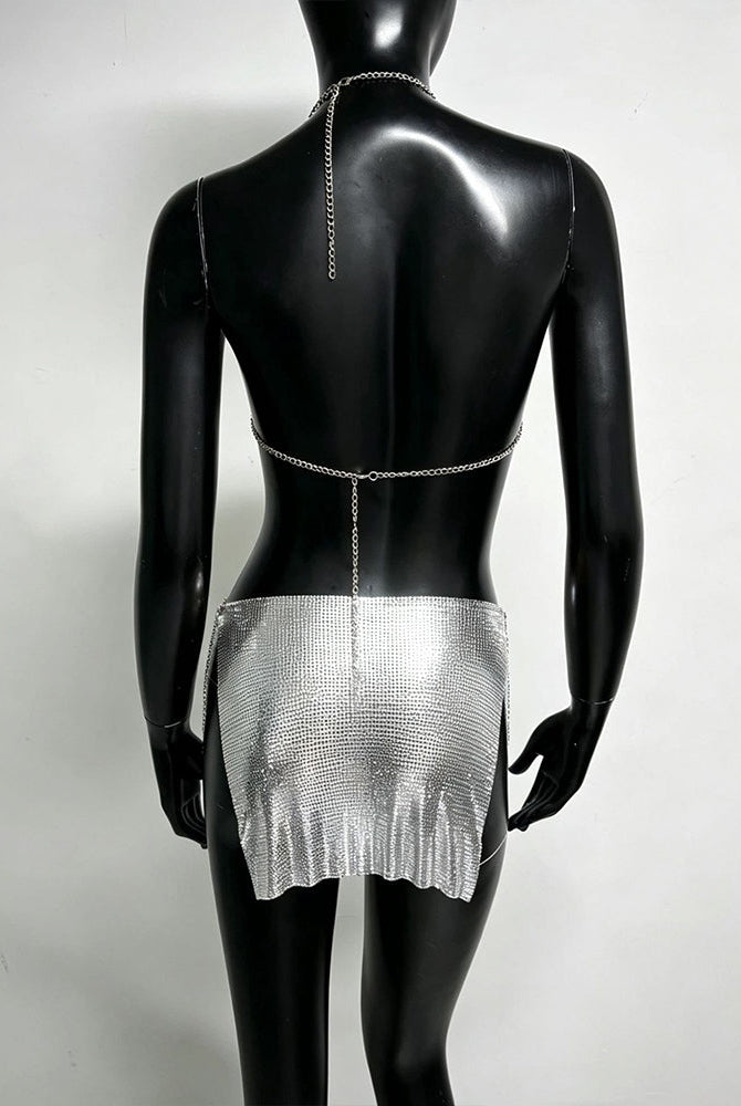 Silver metallic chain bra top and mini skirt set on mannequin, open back chains