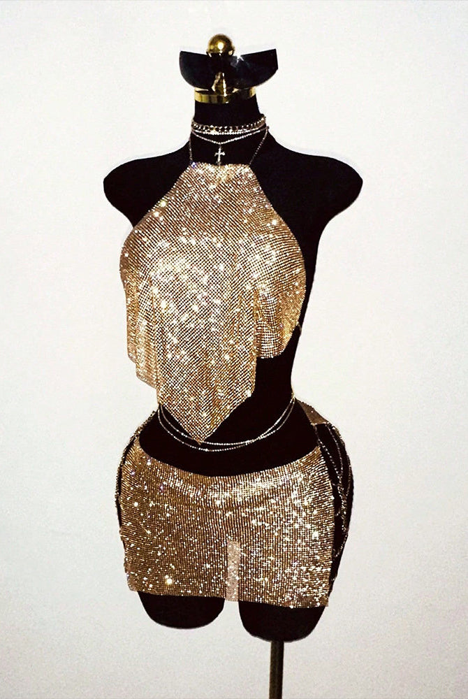 Gold rhinestone halter top and mini skirt set on mannequin, matching fringe