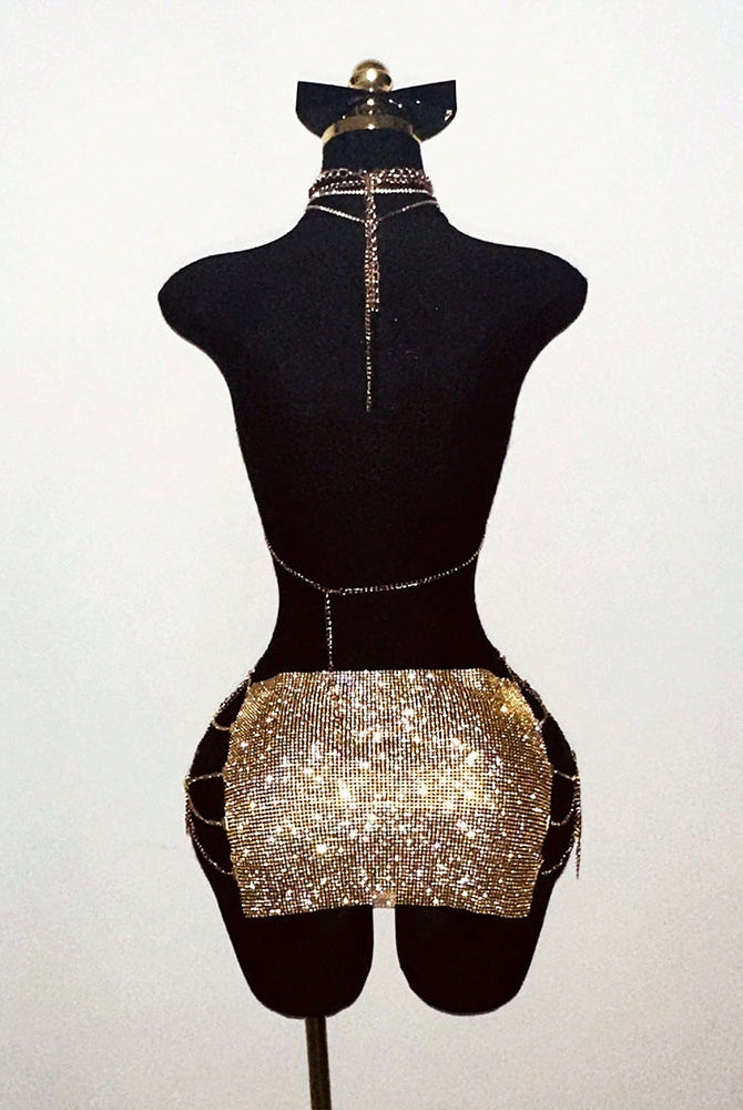Gold rhinestone halter top and mini skirt set on mannequin with long chain ties