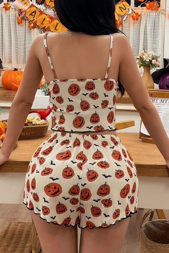 Back view: white crop cami and shorts pajama set with pumpkin and ghost print, ruffled hem