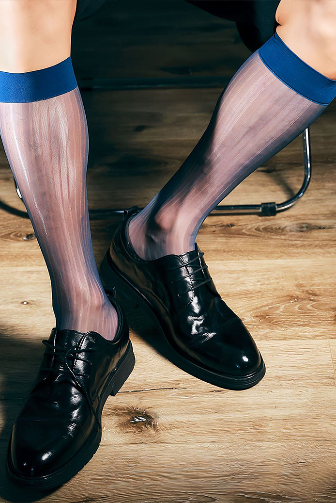 Sheer mid-calf dress socks with dark blue band at top, worn with black dress shoes