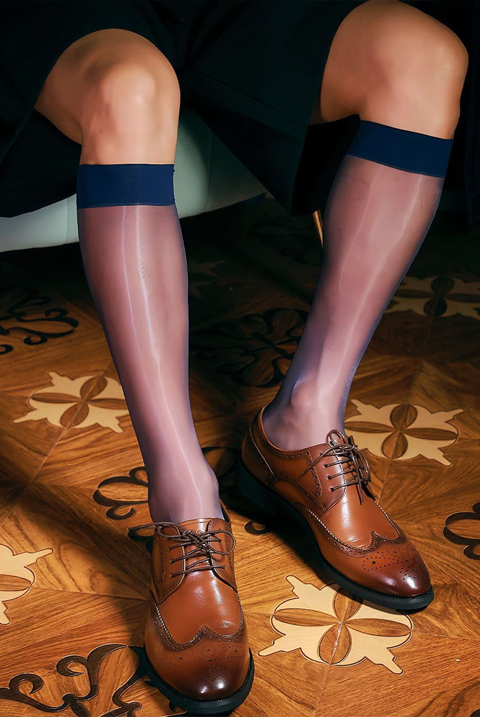 Sheer mid-calf dress socks with dark blue band at top, worn with brown dress shoes