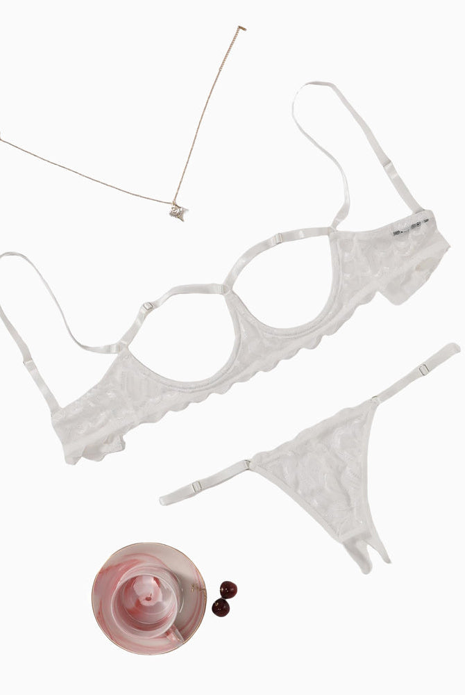 White lace cupless lingerie set with adjustable straps and a matching thong, perfect for women.