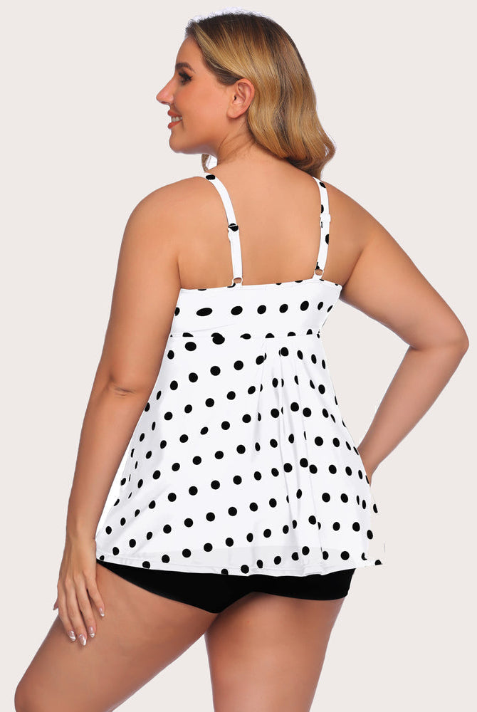Polka dot tankini swimsuit with adjustable straps and black shorts. Retro swimwear style