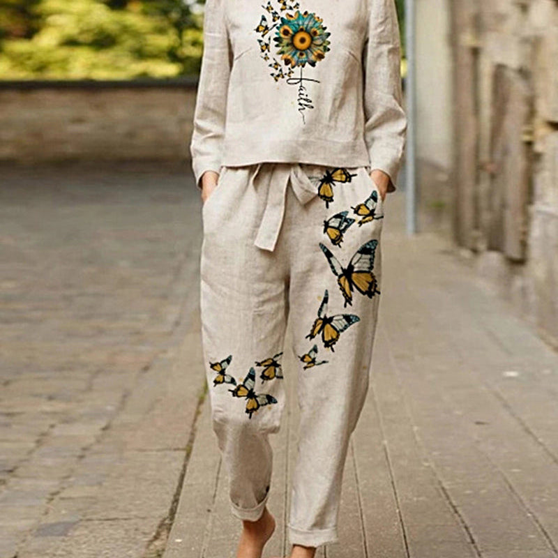 Print tracksuit: beige linen top with sunflower, "Faith" text, and butterfly print pants.