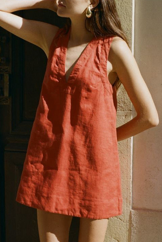 Sleeveless loose mini dress in red-orange linen-cotton blend, perfect for vacation wear.