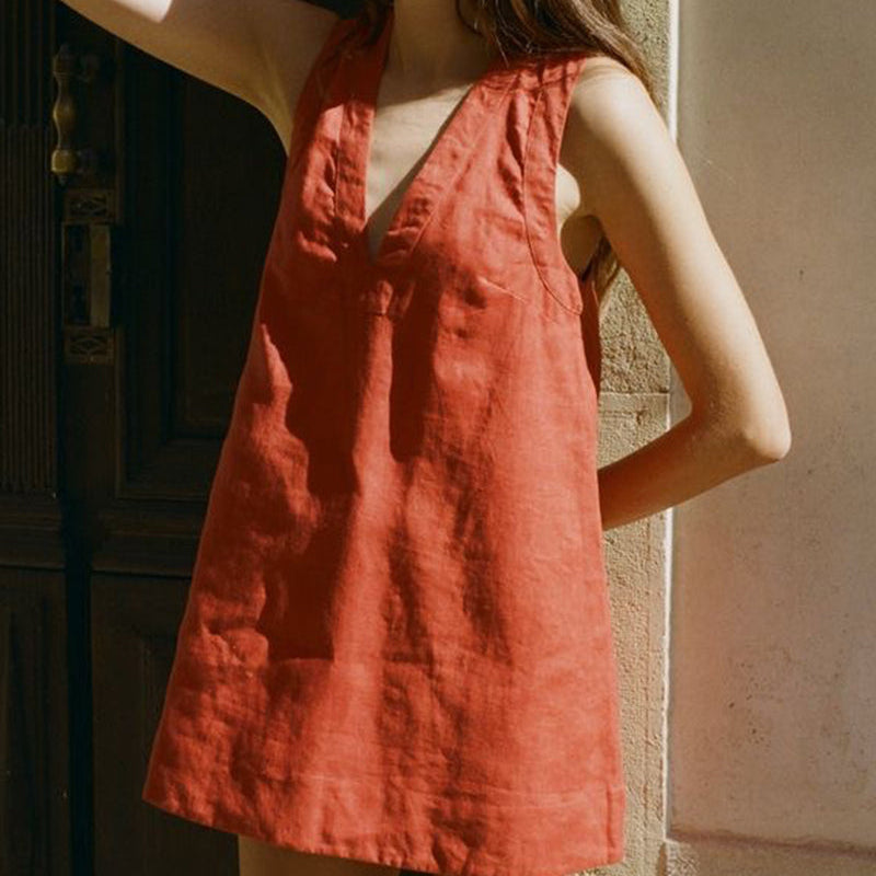 Sleeveless loose mini dress in red-orange linen-cotton blend, perfect for vacation wear.