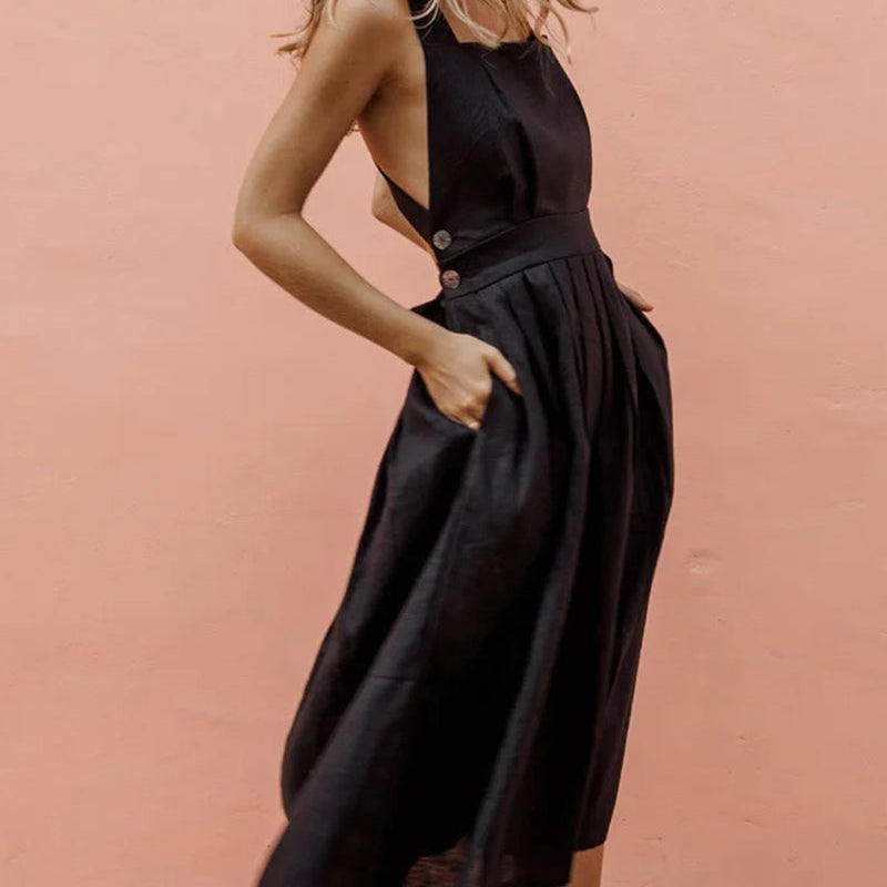 Black strap button waist pleated dress for vacation, featuring halter neckline and pleated skirt