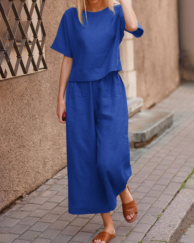 Blue linen two-piece set for women, casual style. Loose fit top and wide leg pants for leisure wear.
