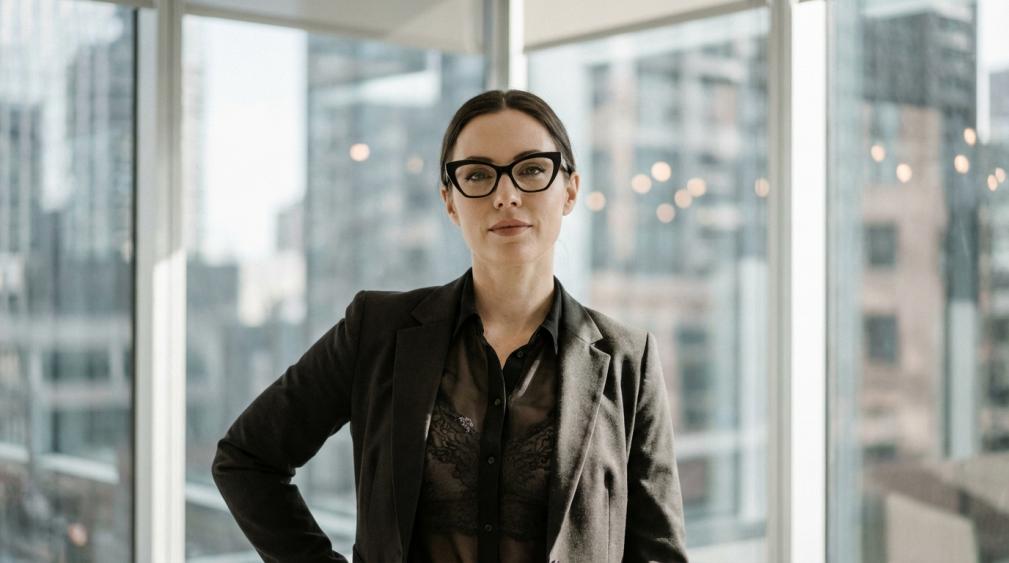 The Evolution of the Office Siren: The Reign of Angular Cat-Eye Glasses and Sheer Tops