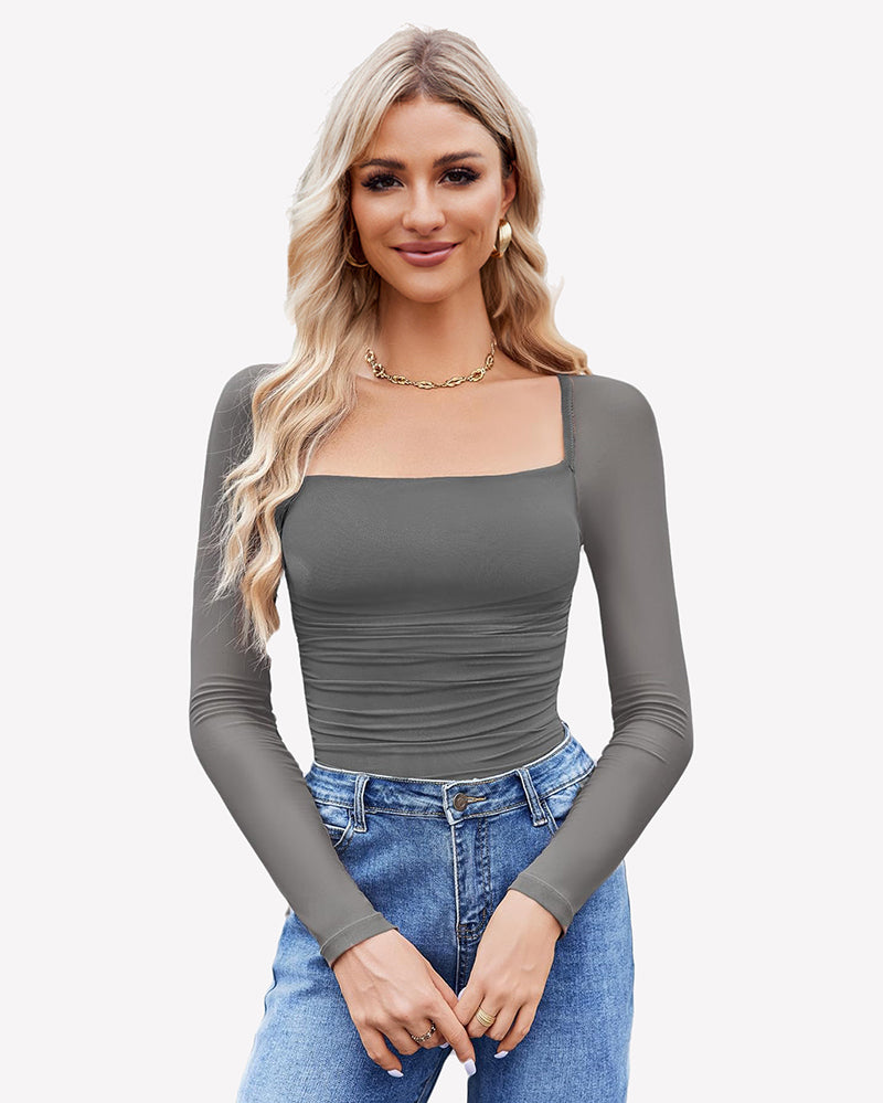 Grey square neck mesh bodysuit with long sleeves, ruched detail. Model in jeans and gold jewelry.