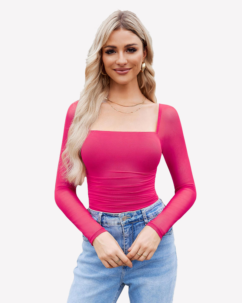 Pink square neck mesh bodysuit with ruched detail and long sleeves. Model in jeans and gold jewelry.