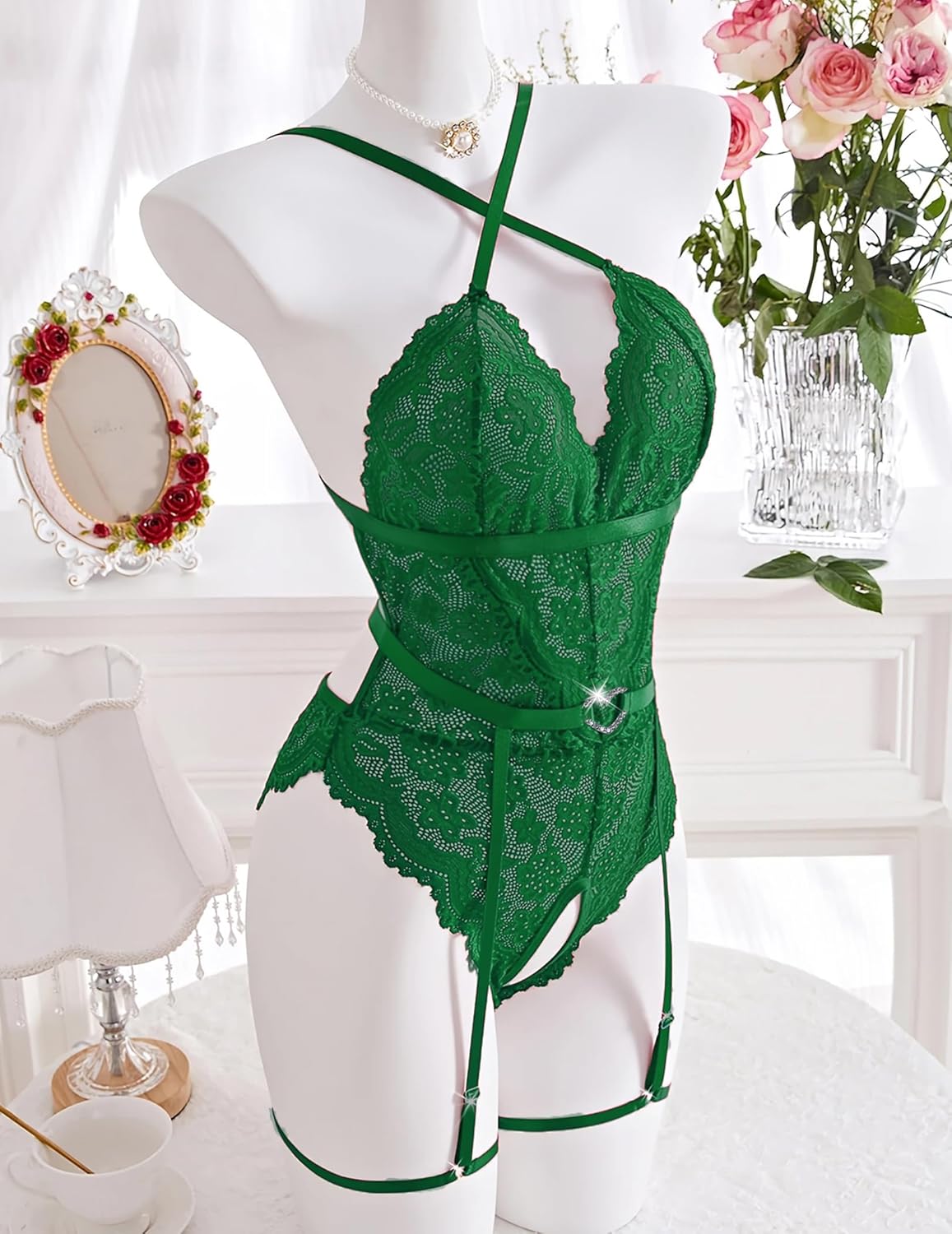 Green lace bodysuit with garter belt, adjustable straps. Sexy lingerie for intimate wear.