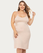 Curvy model in fitted light pink plus-size chemise nightgown with adjustable straps.