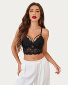 Burgundy lace bralette with adjustable straps modeled from the back with black high-waisted jeans.