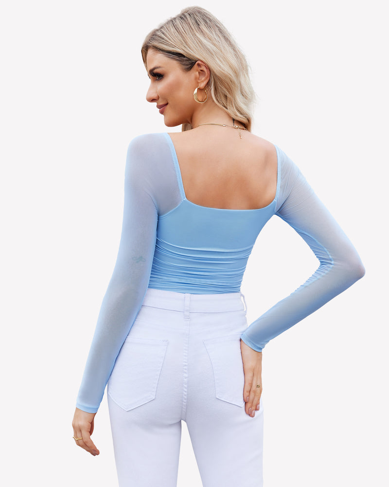 Light blue mesh bodysuit shapewear with ruched detail, long sleeve, and model in white jeans