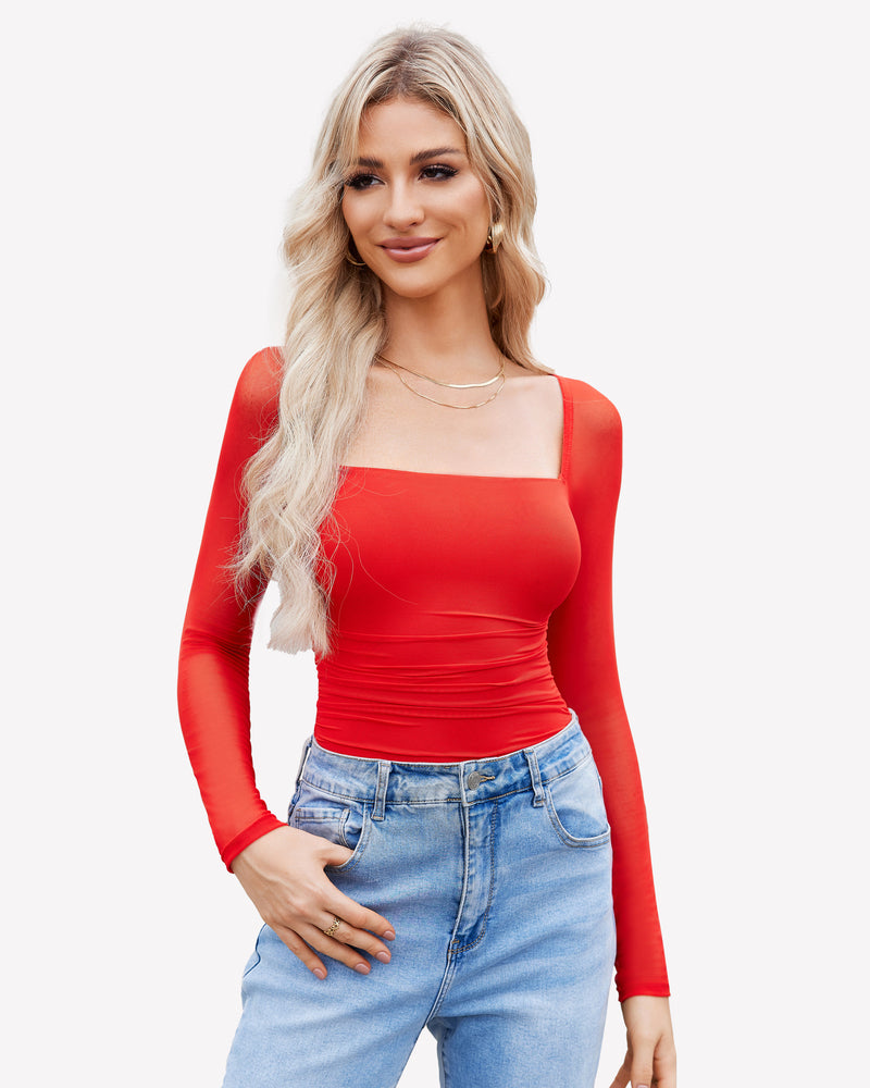 Red mesh square neck bodysuit with long sleeves, ruched detail. Model in blue jeans and gold jewelry