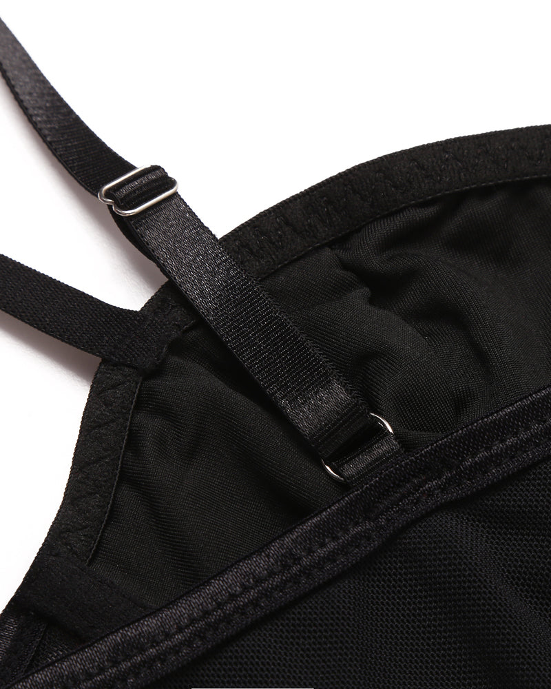 Black corset top detail: adjustable straps, mesh material, and hook closure, perfect for nights out.