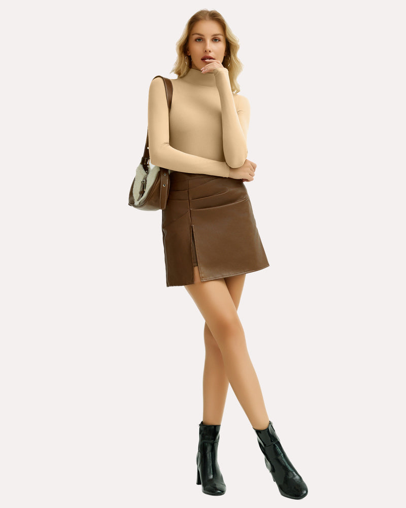 Woman in beige high-neck bodysuit and brown leather skirt, a stylish outfit.