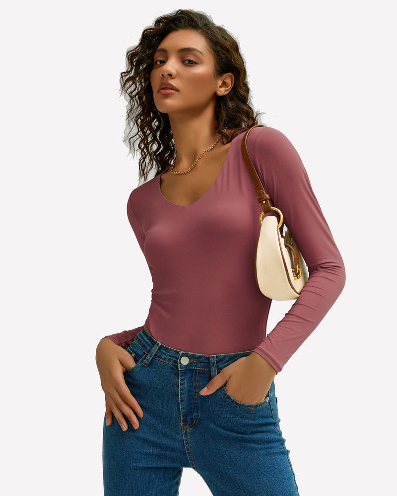 Mauve V-neck long sleeve top with jeans. Soft, stretchy fabric. Modern and stylish outfit.