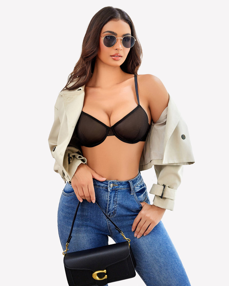 Black sheer mesh underwire bra, modern lingerie, stylish outfit with jeans and trench coat.