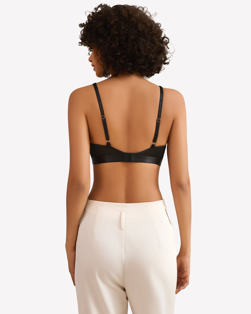 Black wireless bralette with adjustable straps, paired with white pants, for everyday wear.