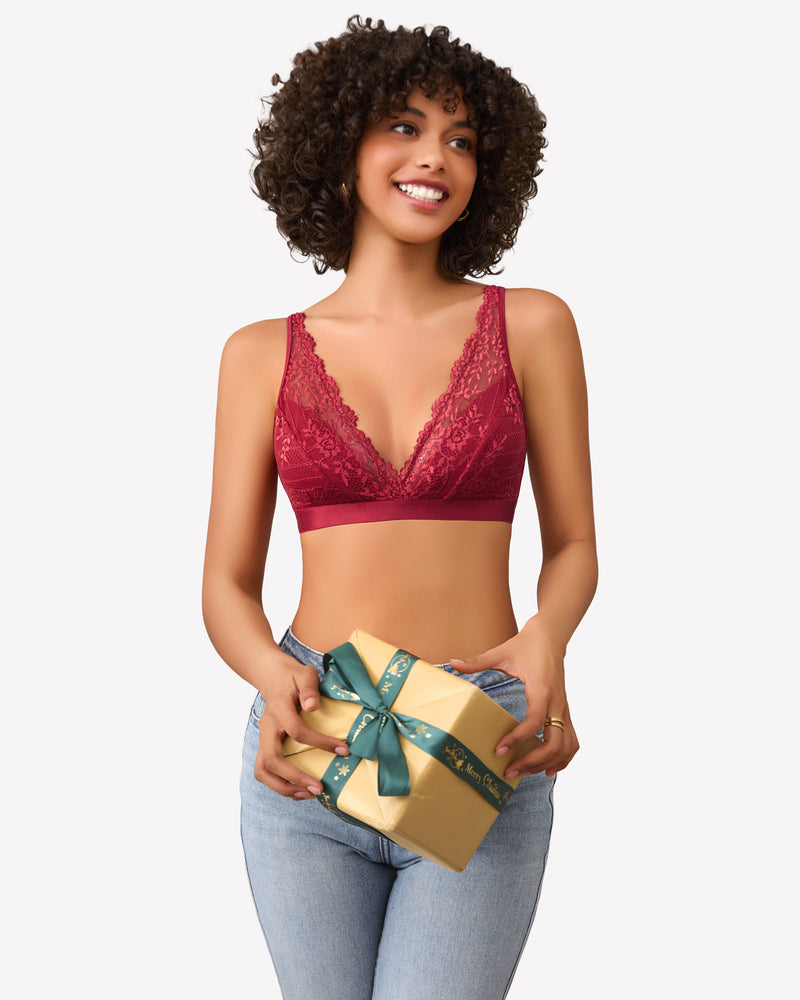 Burgundy lace bralette with adjustable straps, holding gift with Merry Christmas ribbon