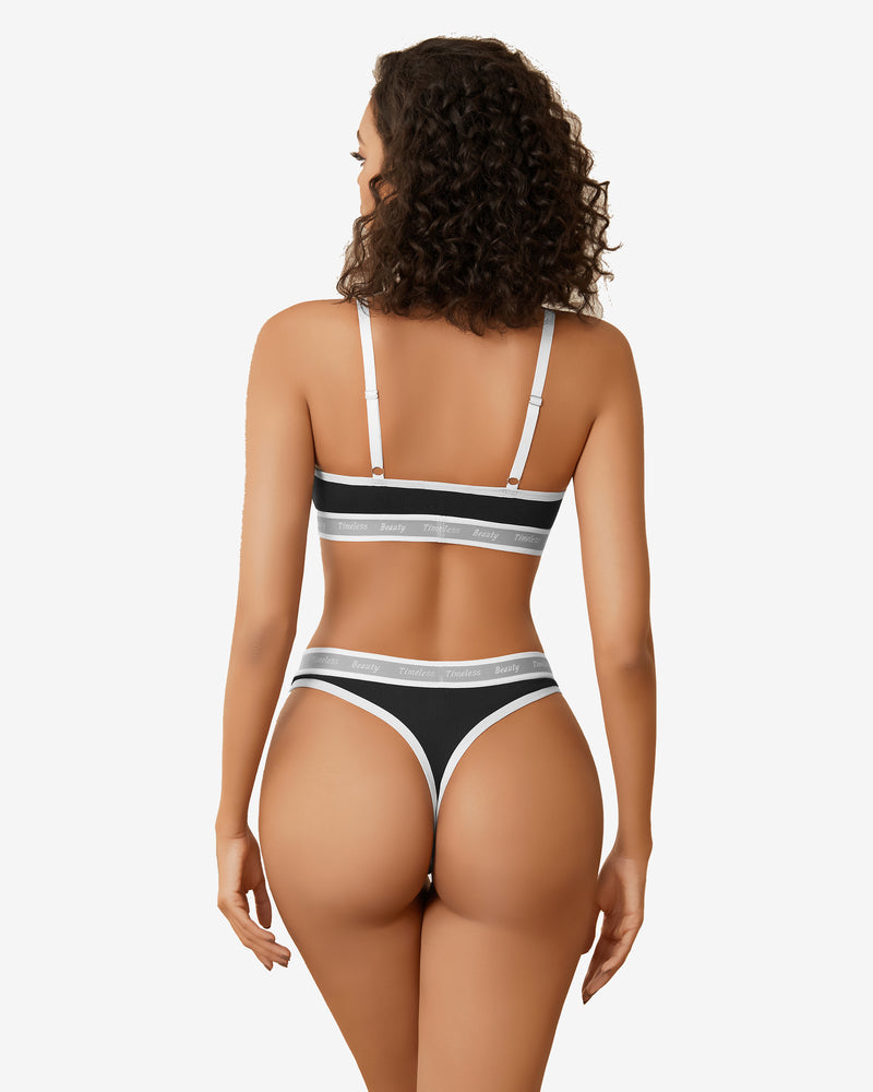 Black contrast lingerie set with white trim and "Timeless Beauty" print