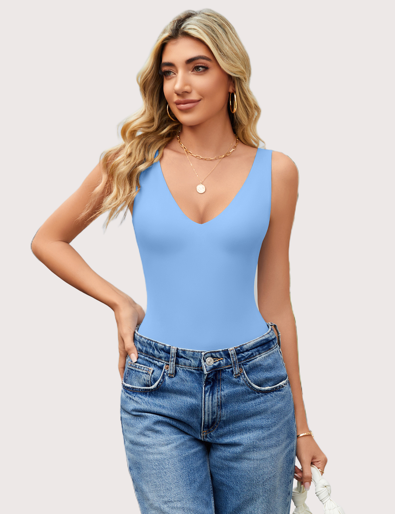 Light blue plunging V-neck bodysuit leotard, a must-have for your wardrobe, paired with blue jeans.