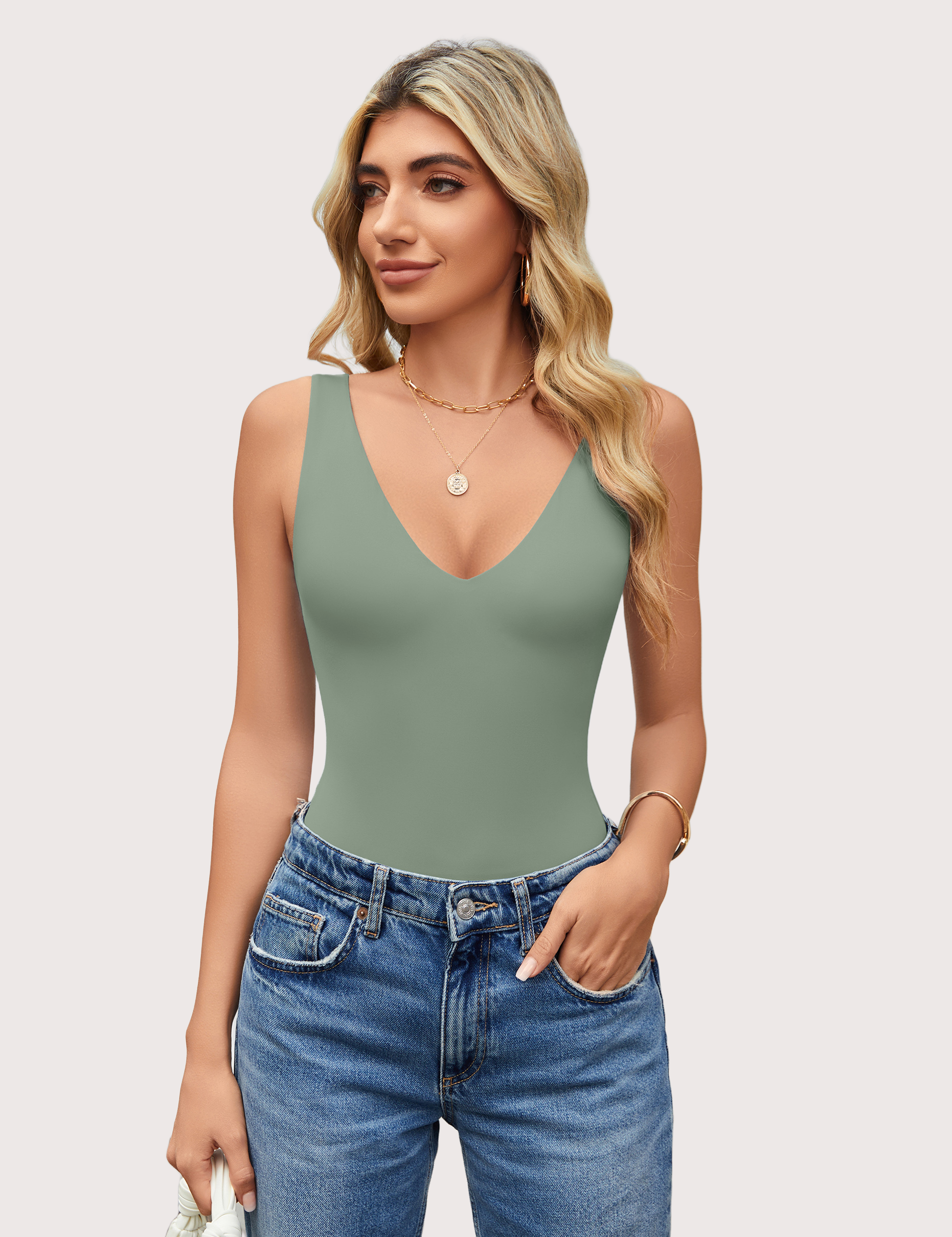 Sage green plunging V-neck bodysuit leotard with blue jeans, a must-have for your wardrobe.