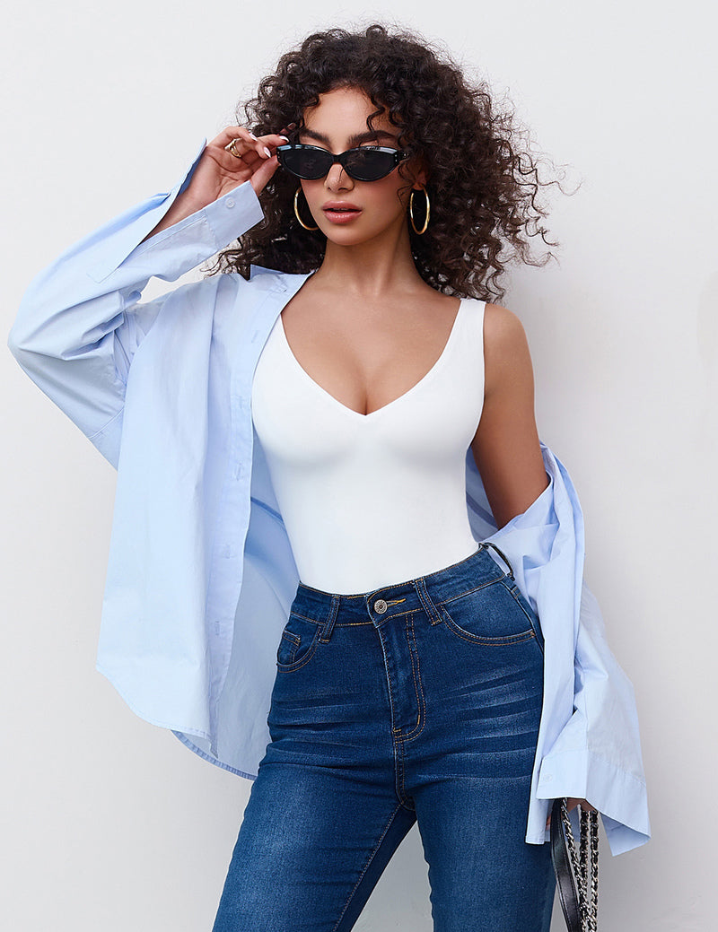 White plunging V-neck bodysuit leotard with blue jeans, a must-have for your wardrobe.