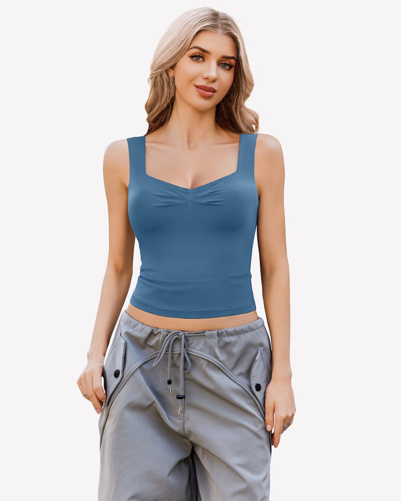 Teal sweetheart neckline crop tank top, ruched detail, sleeveless Y2K style, with grey pants.