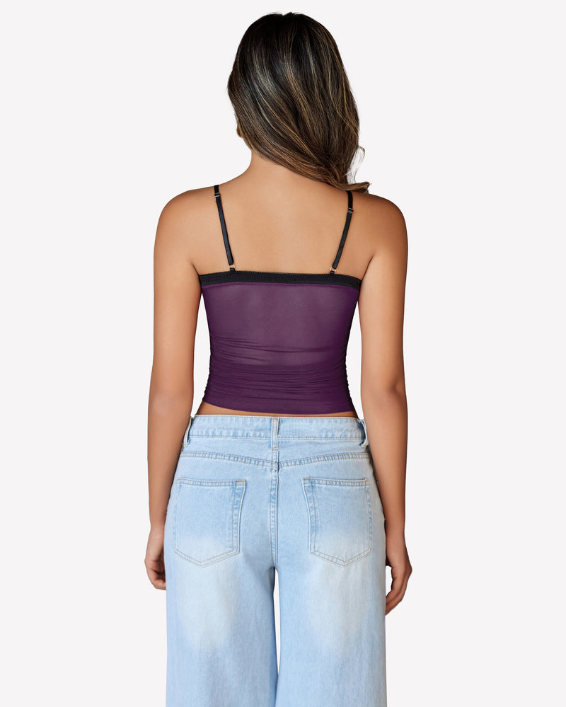 Purple ruched mesh crop top, Y2K style, with spaghetti straps and light blue jeans, back view