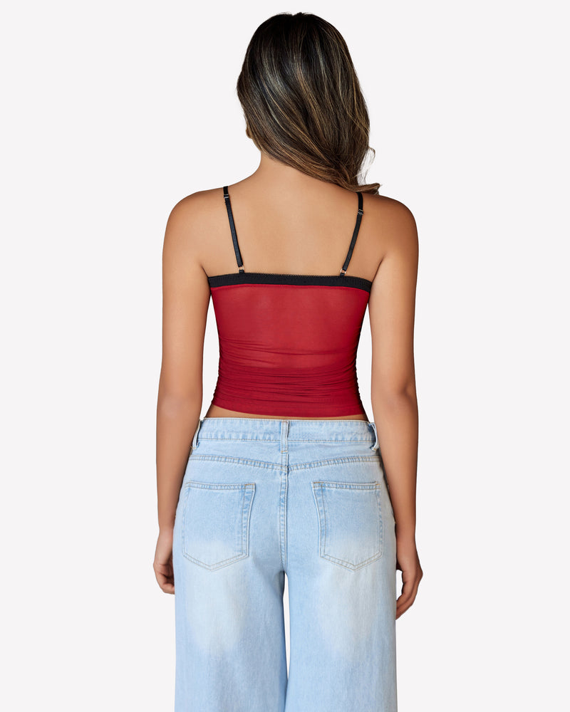 Burgundy mesh crop top with spaghetti straps, Y2K style, paired with light blue jeans