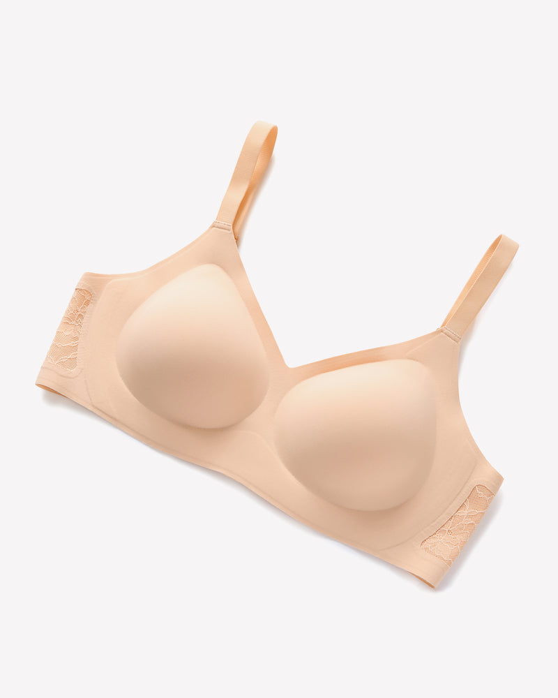 Beige seamless V-neck bra with lace detail, wireless support, and adjustable straps for women